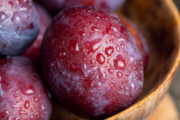 Ripe delicious plums of dark color