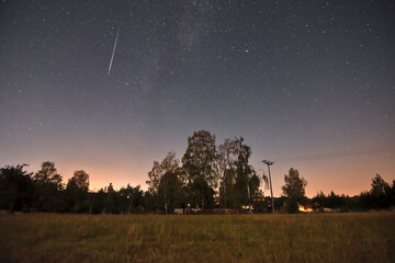 bright shooting star of the Perseids in a summer night