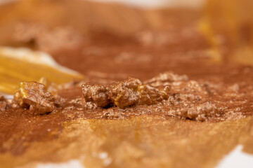 Abstract background painted with gold acrylic paints