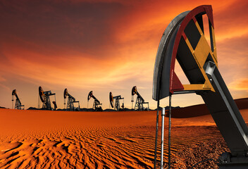 Oil pumps in desert at sunset