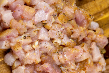 Sliced raw chicken fillet with spices