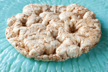 Crispbread on blue. Rice crisp bread on a blue textured plate. Healthly food