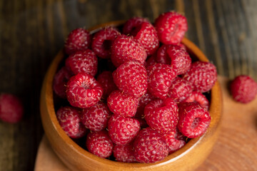 Harvested red ripe raspberries in the kitchen