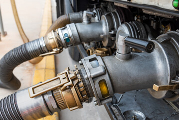 Devices attached to the mouths of a tanker truck to connect the discharge hoses,discharging diesel...