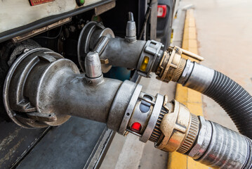 Devices attached to the mouths of a tanker truck to connect the discharge hoses, discharging...