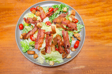 Salad with bacon and cheese and Caesar dressing
