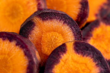 Pieces of sliced peeled carrots are red-orange in color