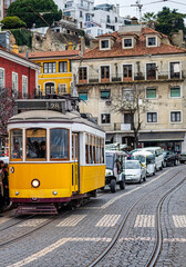 Naklejka na ściany i meble Famous Vintage Tram In The Center Of Lisbon Old Town Picking Up Passengers. Travel Concept