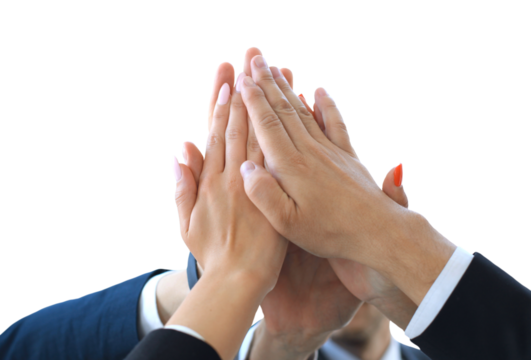 Business team joining hands together standing in office.