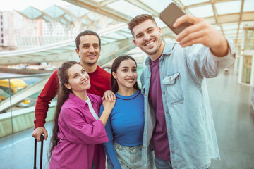 Two Happy Couples Traveling Making Selfie Having Fun In Airport