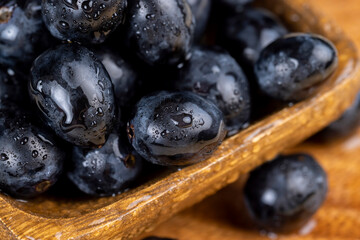 sweet ripe black grapes covered with drops of water