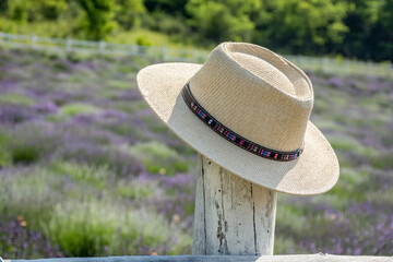 straw hat on a wooden fence