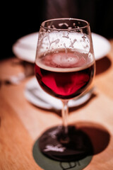 Vertical fancy Belgian beer glass close up with foam