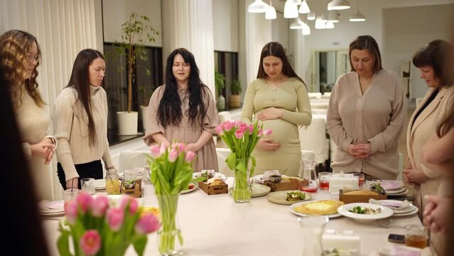 People pray to God at the table