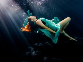 Fototapeta na wymiar Reagan Swenson underwater with dress floating