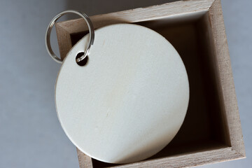 wooden key ring tag in a wooden box close up - macro lens, particular focus