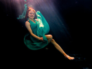Reagan Swenson underwater with dress floating