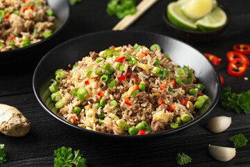 Asian Beef Fried Rice with eggs and vegetables in black bowl