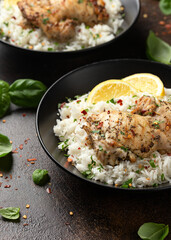 Grilled Chicken thighs served with rice in a black bowl