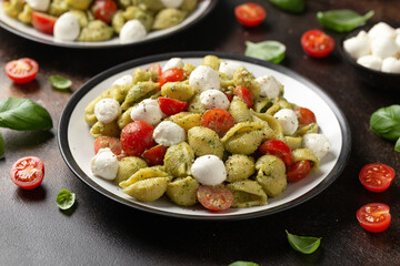 Pesto Pasta Salad with Cherry Tomatoes and Mozzarella cheese. Healthy food.