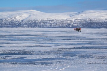 Silhouettes of tourists on snowshoes on lake Tornetr&auml;sk (Tornestrask) around Abisko National Park (Abisko nationalpark) in winter scenery. Sweden, Arctic Circle, Swedish Lapland