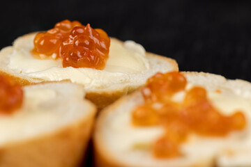 Thinly sliced baguette with salmon caviar and butter