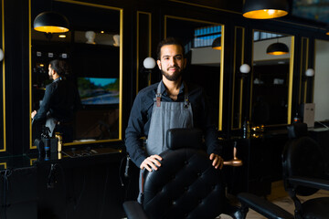 Portrait of a professional barber smiling ready for a customer