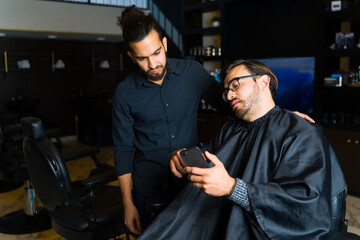 Young man customer asking for a new haircut at the salon