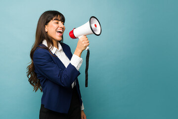 Excited professional woman using a megaphone