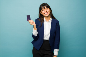 Happy business woman feeling successful with a credit card