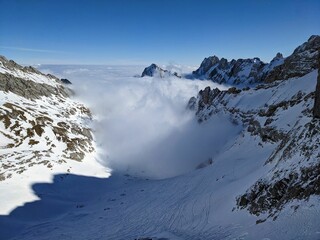 Fototapeta na wymiar Ski tour just above the sea of fog. Lake of Fog. Mountaineering in winter in the Alpstein region of Switzerland. Skiing in the Alps. Appenzell Toggenburg Säntis. High quality photo.