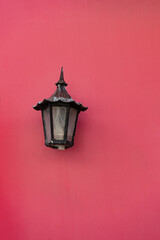 Fototapeta na wymiar streetlamp lantern on pink wall, copy space. streetlamp lantern on house. streetlamp lantern outdoor.