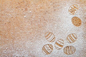 Easter eggs made of flour on chopping board, easter baking background concept, top view, copy space