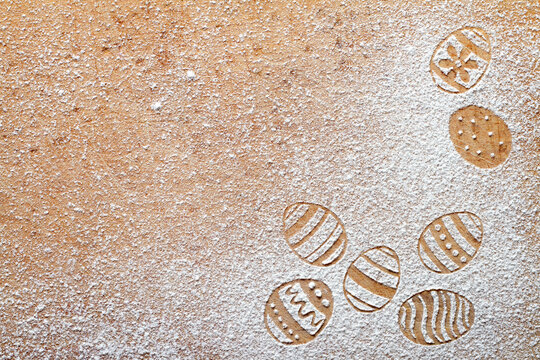 Easter eggs made of flour on chopping board, easter baking background concept, top view, copy space