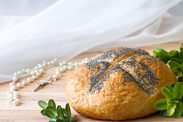 Easter loaf of bread with boxwood and rosary, easter religious concept