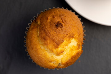 Soft and fresh fragrant wheat cupcake on a black stone