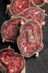 Unpeeled sliced pork salami with spices