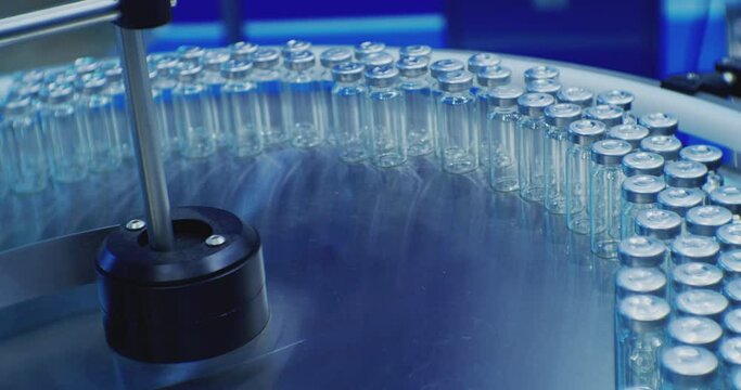 pharmaceutical industry.automatic production line machine conveyor with empty glass bottles at pharmacy processing factory. Medicine manufacturing and automated technology equipment.close-up.