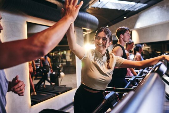 Woman high-fiving a workout partner