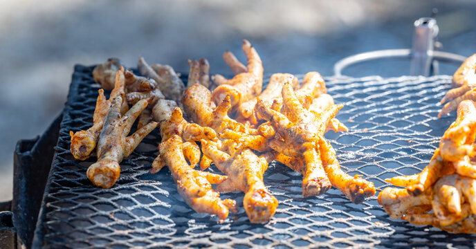 Grilled chicken feet on a charcoal grill in the township of Langa near Cape Town