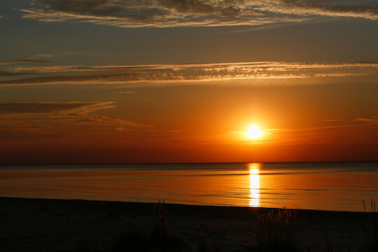 Sunset photo over calm reflective ocean