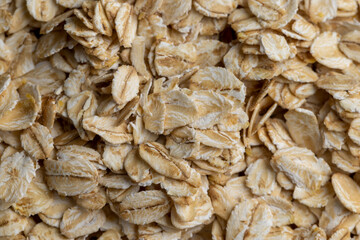 Poured a large amount of oat flakes close-up