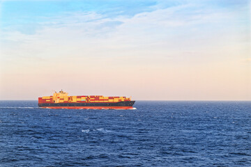 Large cargo ship sailing in open sea on sunny day