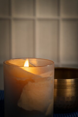 burning wax candle and Tibetan singing bowl, meditation and relaxation concept