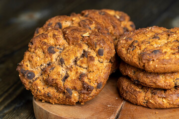 Delicious cookies with pieces of chocolate on the table