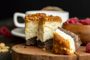 Cheesecake with chocolate sponge cake and peanuts in caramel