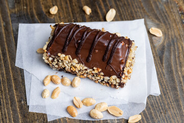 Fresh sweet cake with banana in chocolate glaze and milk filling
