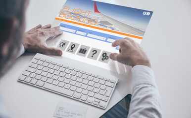 Businessman booking flight ticket on virtual desktop screen. Plan travel and book business trip