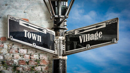 Obraz premium Street Sign to Village versus Town