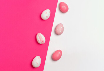 Minimal concept Easter eggs on pink and white background. Flat lay.